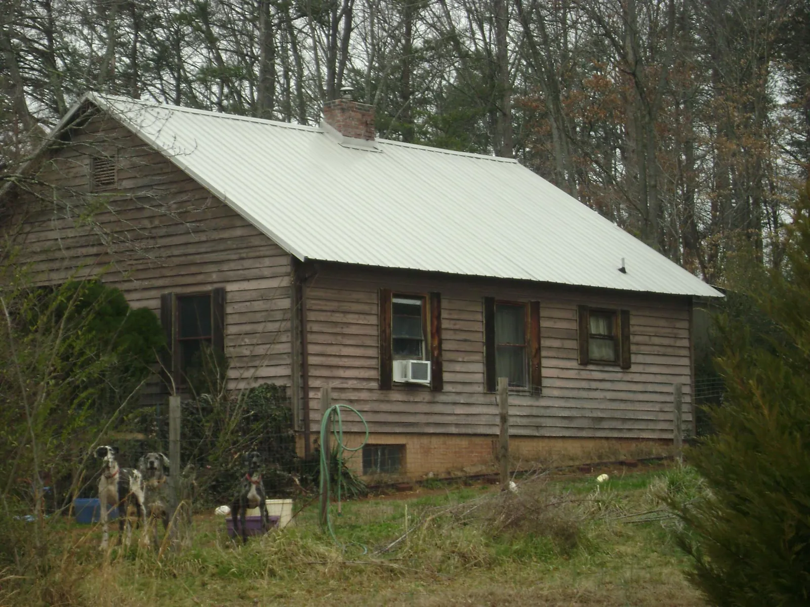 White metal roof on an old wood sided farmhouse, from a Metal Roof Installation job in San Jose